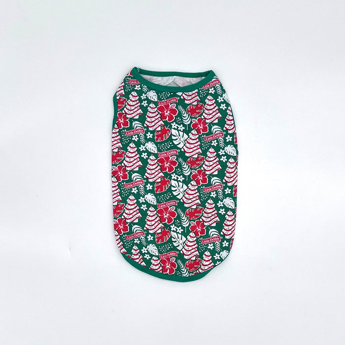 Front-view Little Debbie Hawaiian Dog shirt showcasing the green Little Debbie Hawaiian pattern, highlighted by red and white designs of Little Debbie Christmas Tree Cakes, Little Debbie Red Ribbon Logos, and an aloha leaf and flower motif.