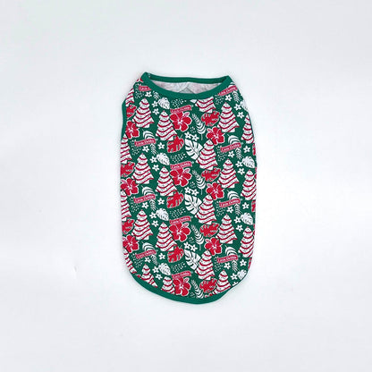Front-view Little Debbie Hawaiian Dog shirt showcasing the green Little Debbie Hawaiian pattern, highlighted by red and white designs of Little Debbie Christmas Tree Cakes, Little Debbie Red Ribbon Logos, and an aloha leaf and flower motif.